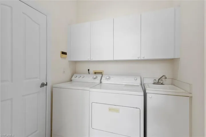 Washroom with washer and dryer and cabinet space