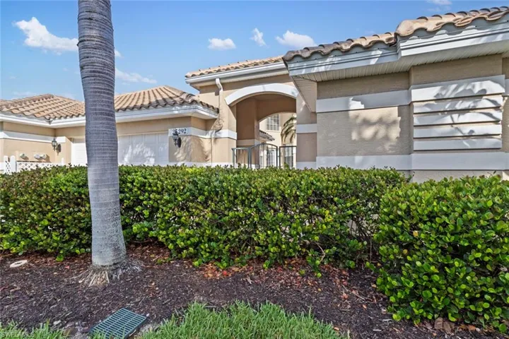 View of front of property featuring a tiled roof, a garage, and stucco siding