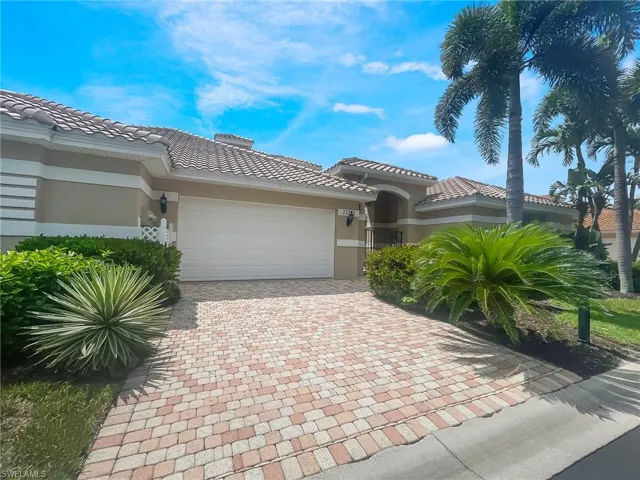 Mediterranean / spanish-style home featuring stucco siding, an attached garage, decorative driveway, and a tiled roof
