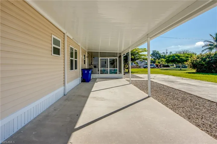 View of patio featuring a sunroom
