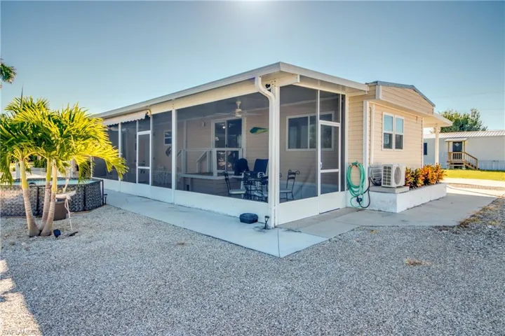 Back of property with a screen lanai