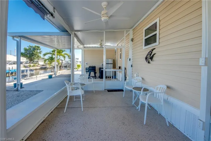 View of patio / terrace featuring a ceiling fan, a water view, and area for grilling