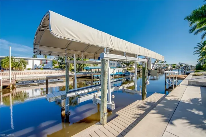 Dock with boat lift and a water view