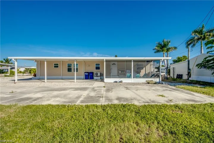 Rear view of property featuring a yard