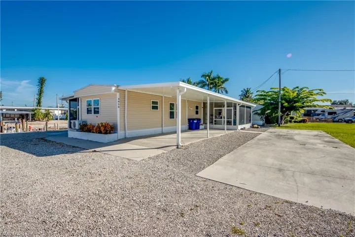 View of front of home with a carport and driveway