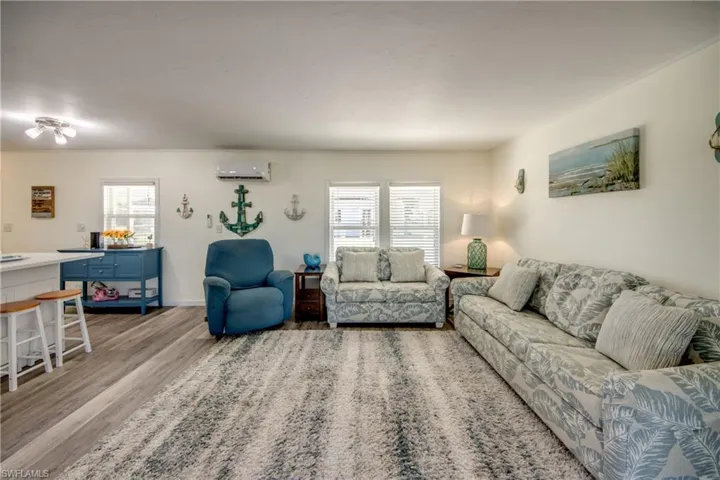 Living area featuring light wood finished floors and ornamental molding