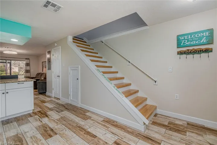 Stairs featuring wood-type flooring