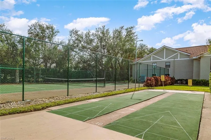 View of community featuring tennis court