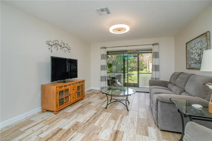 Living room with light hardwood / wood-style flooring