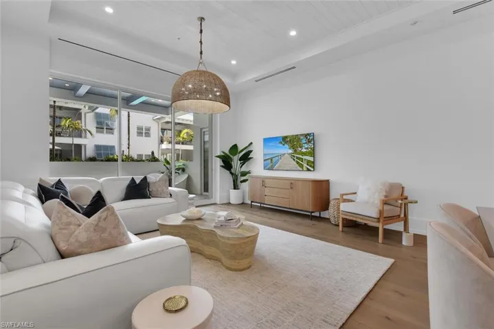 Living room with recessed lighting, wood finished floors, wood ceiling, and baseboards