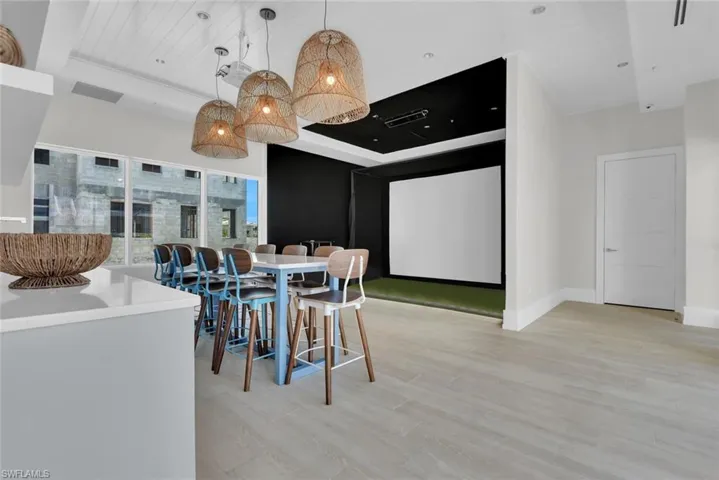 Dining area with light wood-style flooring, baseboards, and a tray ceiling