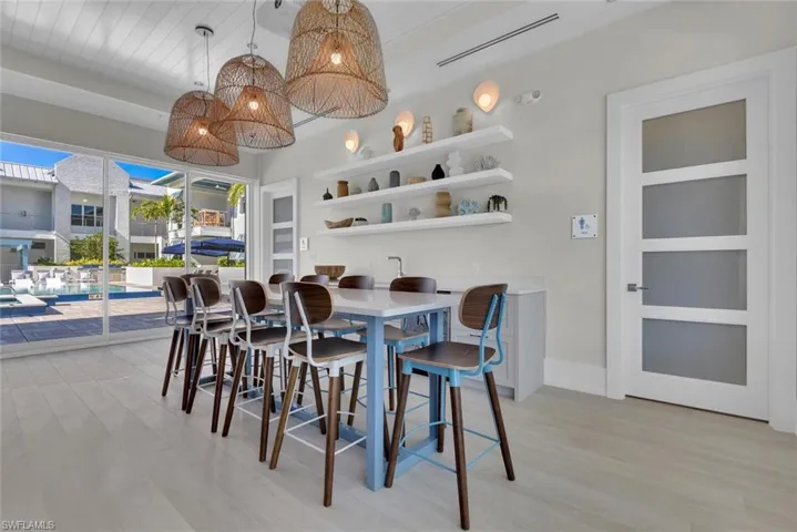 Dining space featuring light wood-type flooring and baseboards