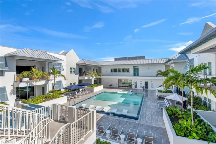 Community pool featuring a hot tub and a patio