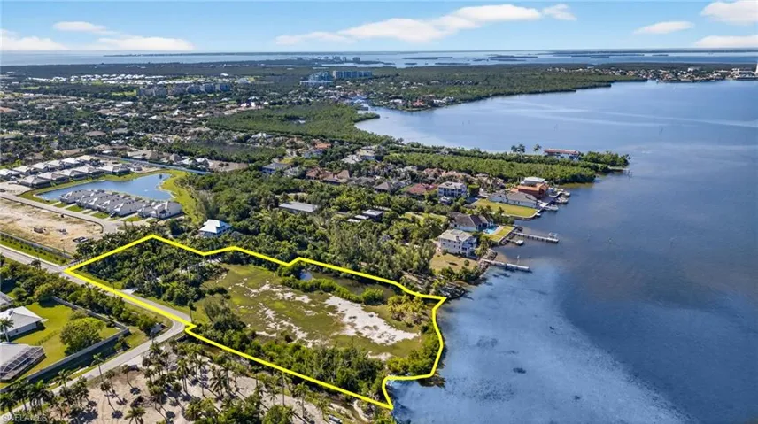Aerial overview of property's location with property boundaries highlighted and a nearby body of water