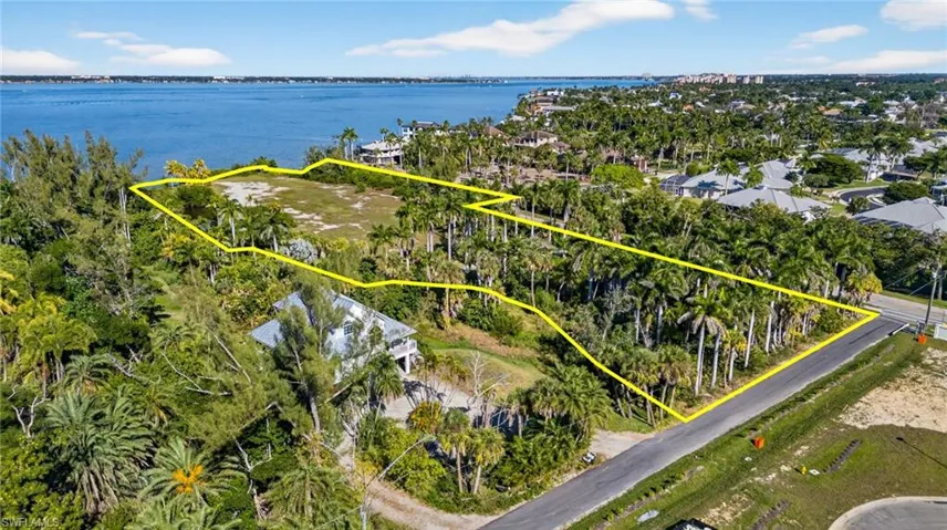 View of property location with a large body of water and property boundaries highlighted