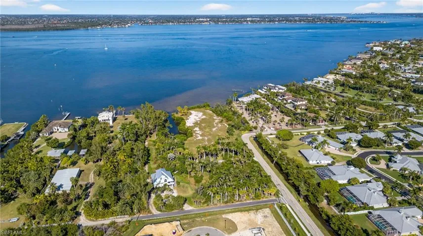 Aerial overview of property's location featuring a large body of water and nearby suburban area