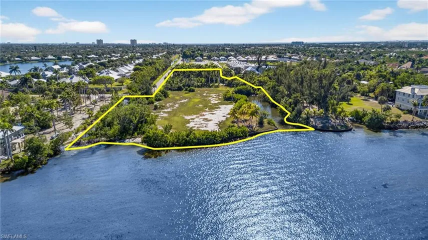 Aerial view of property's location featuring a nearby body of water and property boundaries highlighted