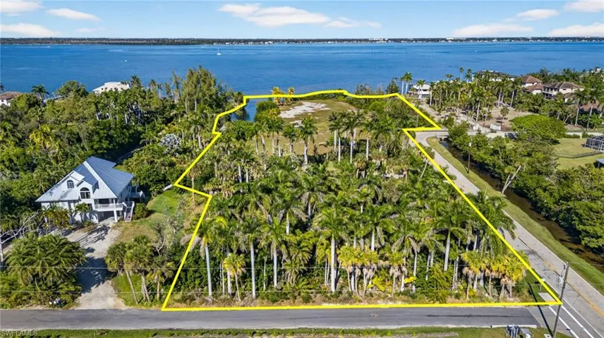 View of property location with a large body of water and property boundaries highlighted