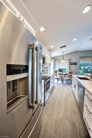 Galley kitchen with Maytag Stainless Steel appliances including French door refrigerator