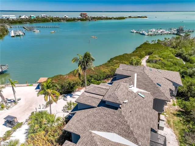 Birds eye view of property with a water view