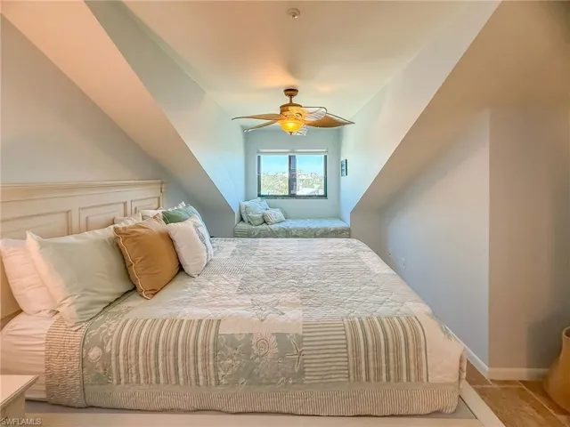 Bedroom with a ceiling fan and baseboards