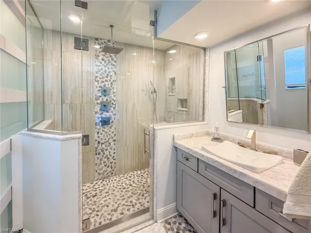Full bathroom featuring a stall shower and vanity
