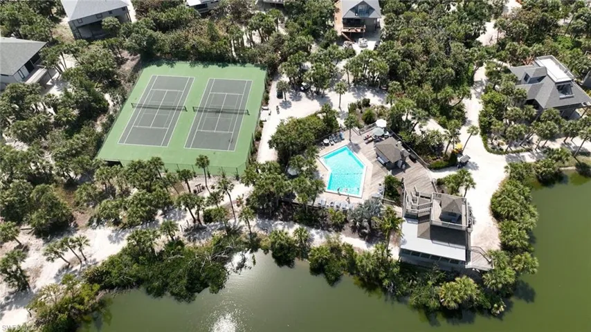 Birds eye view of property with a water view
