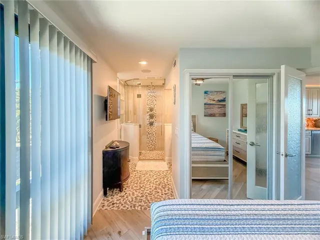 Bedroom featuring light wood-style flooring, baseboards, and a closet