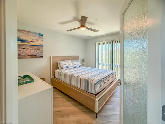 Bedroom with light wood-style flooring and a ceiling fan