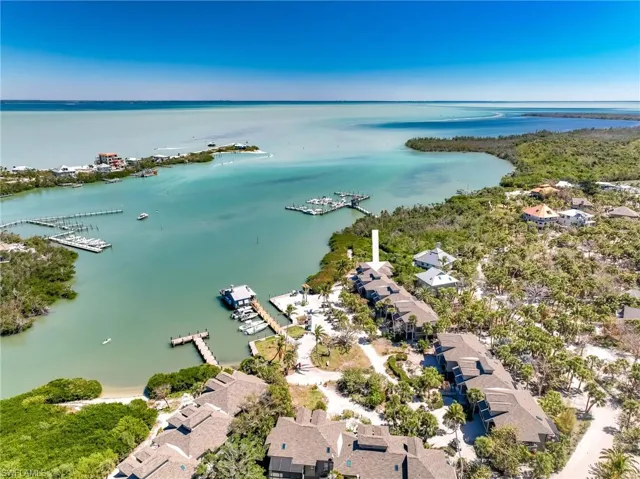 Birds eye view of property with a water view