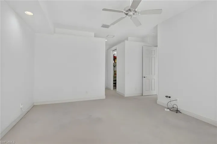 Primary suite, hallway to two walk in closets and primary bathroom.