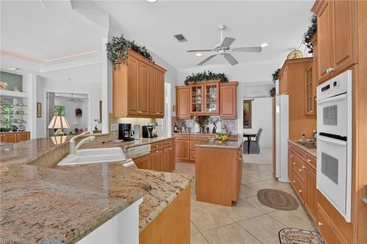 Classic wood design kitchen flows into dining room, breakfast area and living room.