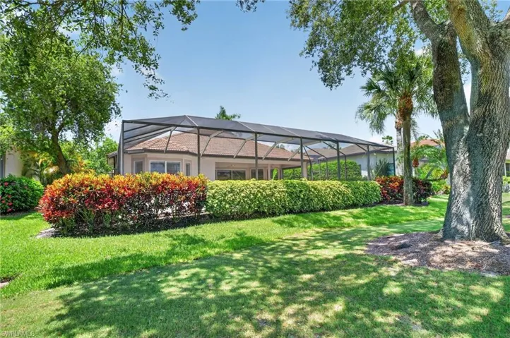 Beautiful shrubs and mature trees at the rear elevation.