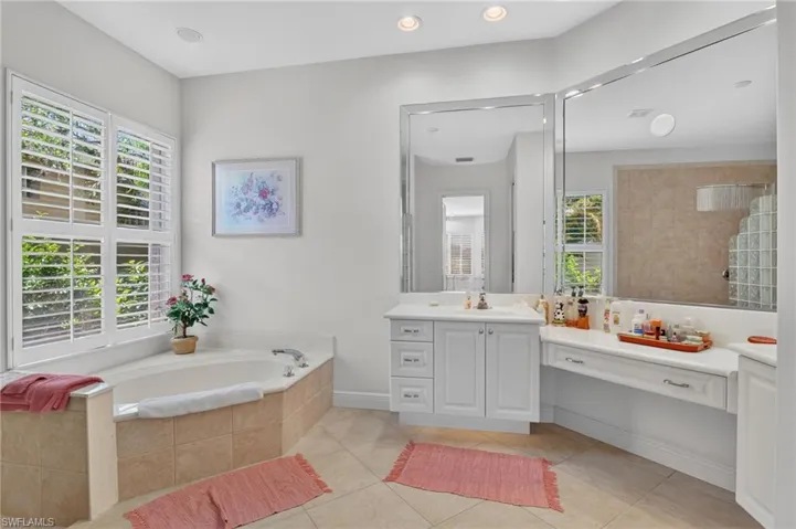 Primary suite bathroom with dual vanities and makeup area.