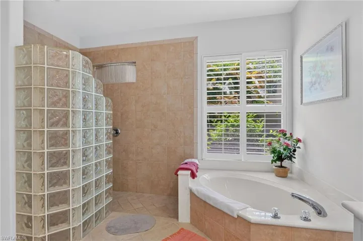 Primary suite bathroom features soaking tub and walk in shower.