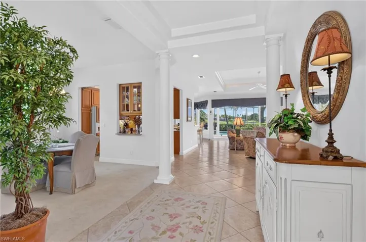 Coming through the front door, the home opens up as the tile leads your eye to the pool and golf course and lake beyond.