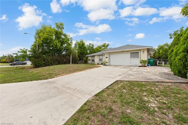 Ranch-style house with driveway, stucco siding, and an attached garage