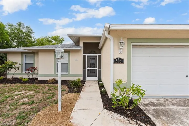 Entrance to property with stucco siding and a garage