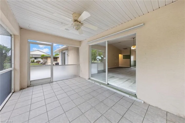 Unfurnished sunroom featuring ceiling fan
