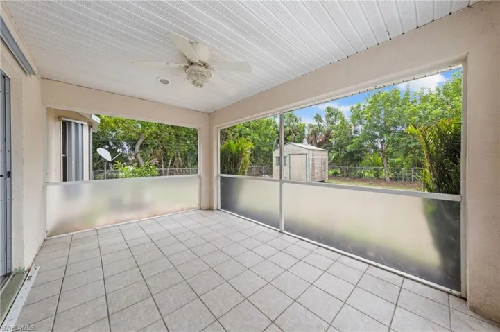 Unfurnished sunroom featuring a ceiling fan and healthy amount of natural light