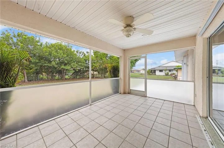 Unfurnished sunroom with ceiling fan