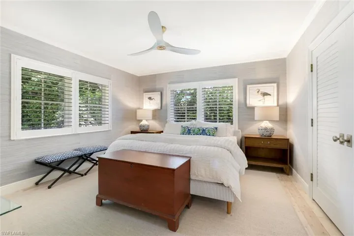 Bedroom featuring ceiling fan and ornamental molding