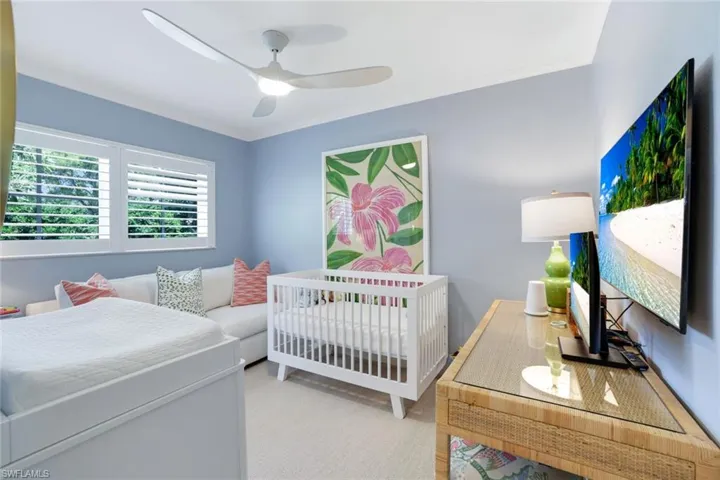 Bedroom with ornamental molding and ceiling fan
