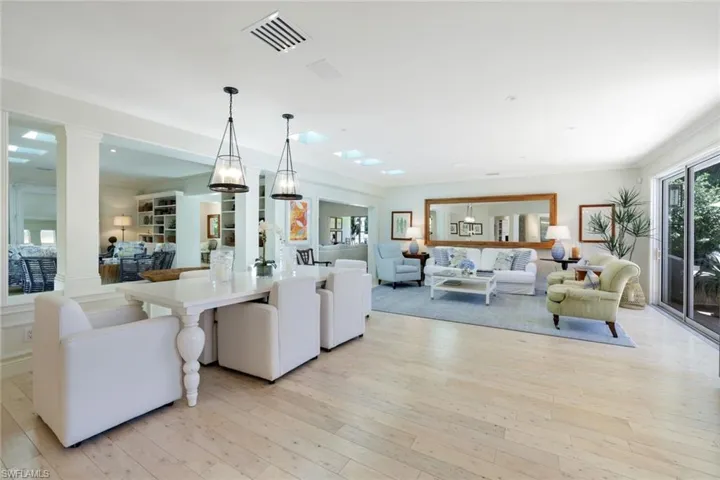Living area featuring light wood-style floors and crown molding