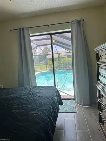 Sliding glass doors opening to a screened pool enclosure with a private pool