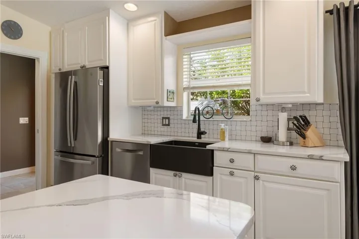 15339 Upwind Dr Bonita Springs FL 34135 - Kitchen with stainless appliances and quartz countertops