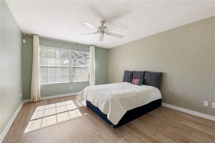 15339 Upwind Dr Bonita Springs FL 34135 - Owner's bedroom with view of the pool deck and long lake beyond