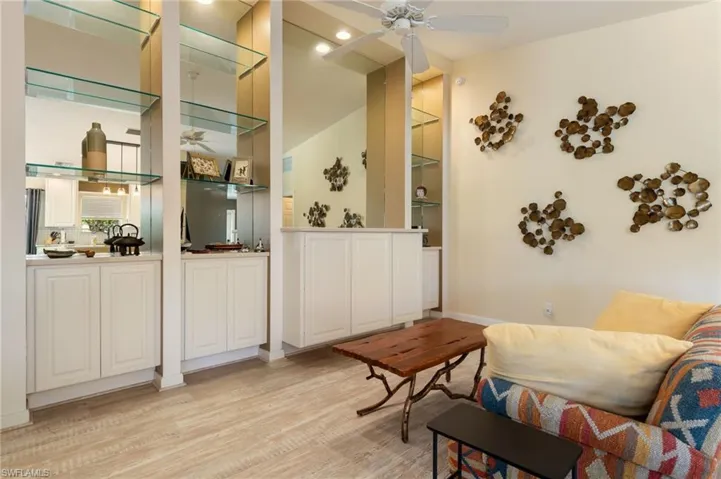 15339 Upwind Dr Bonita Springs FL 34135 - Living room with lighted wall unit provides extra storage.