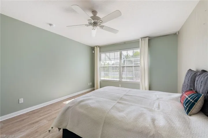 15339 Upwind Dr Bonita Springs FL 34135 - Owner's bedroom with lake view features 2 closets with "California" style adjustable shelves and rods.