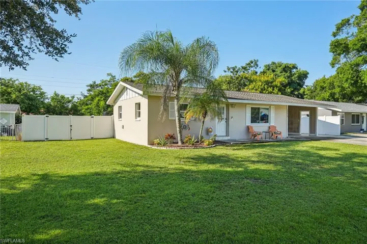View of front of home with a gate, stucco siding, and covered porch
